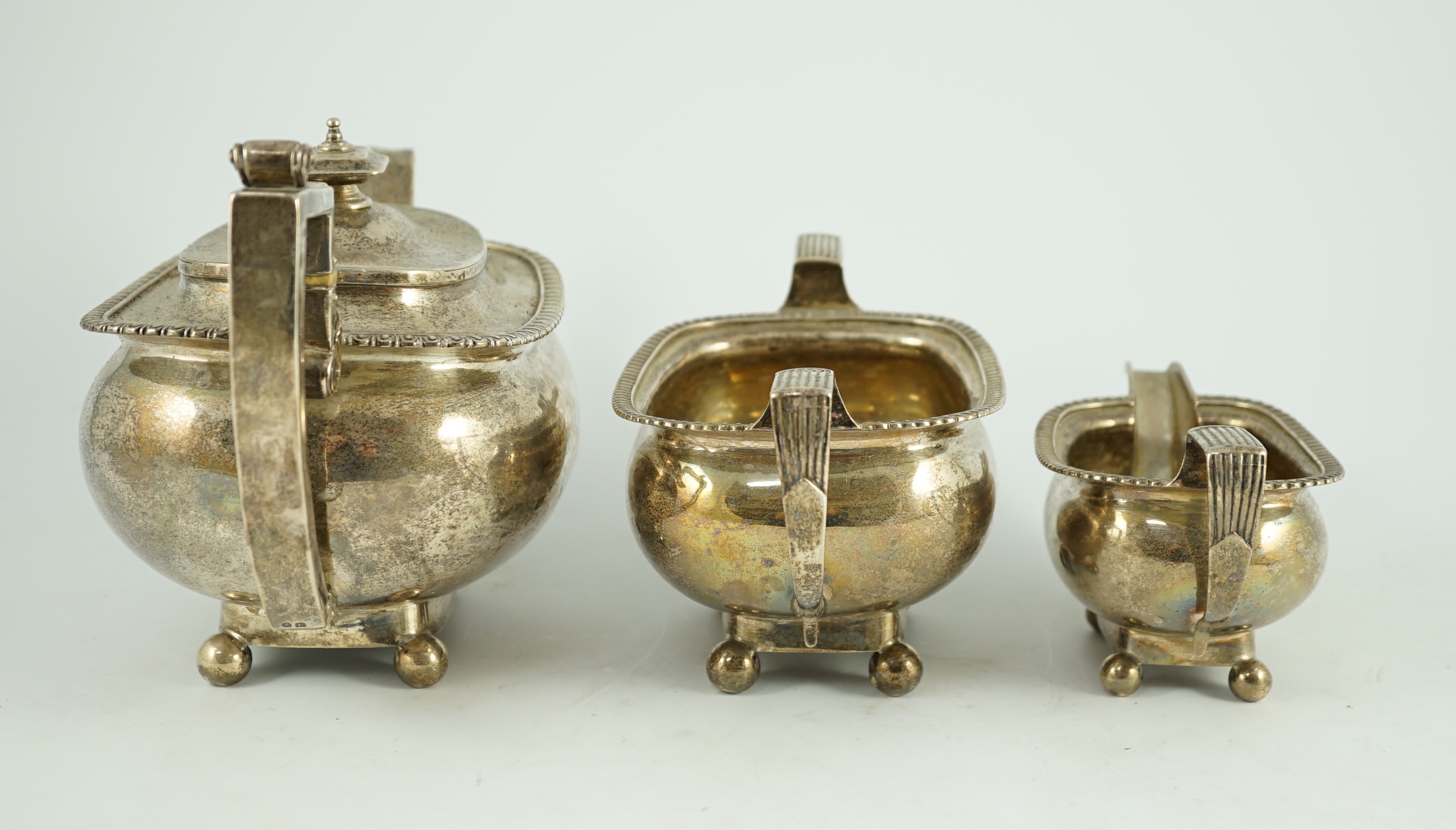 A George III silver three piece 'London' shape tea service, by Samuel Hennell